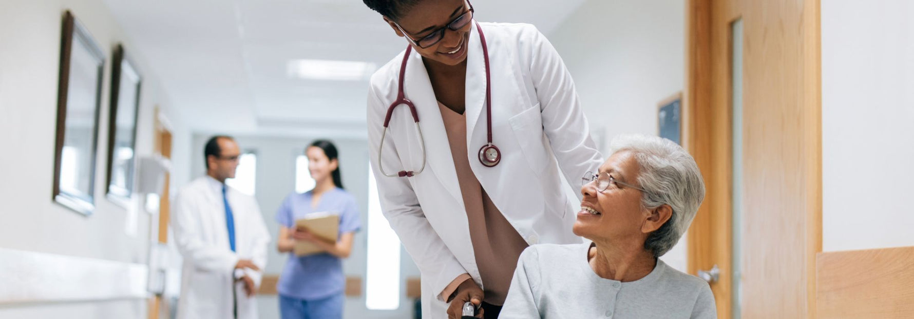 Healthcare patient being pushed in a wheelchair having a positive patient experience